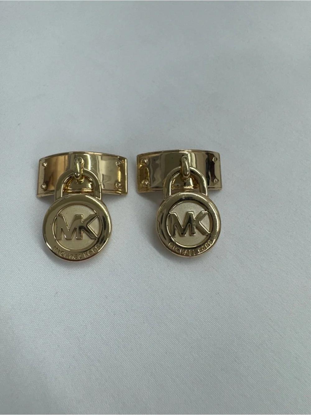 These are golden-tone replacement hardware pieces by Michael Kors .